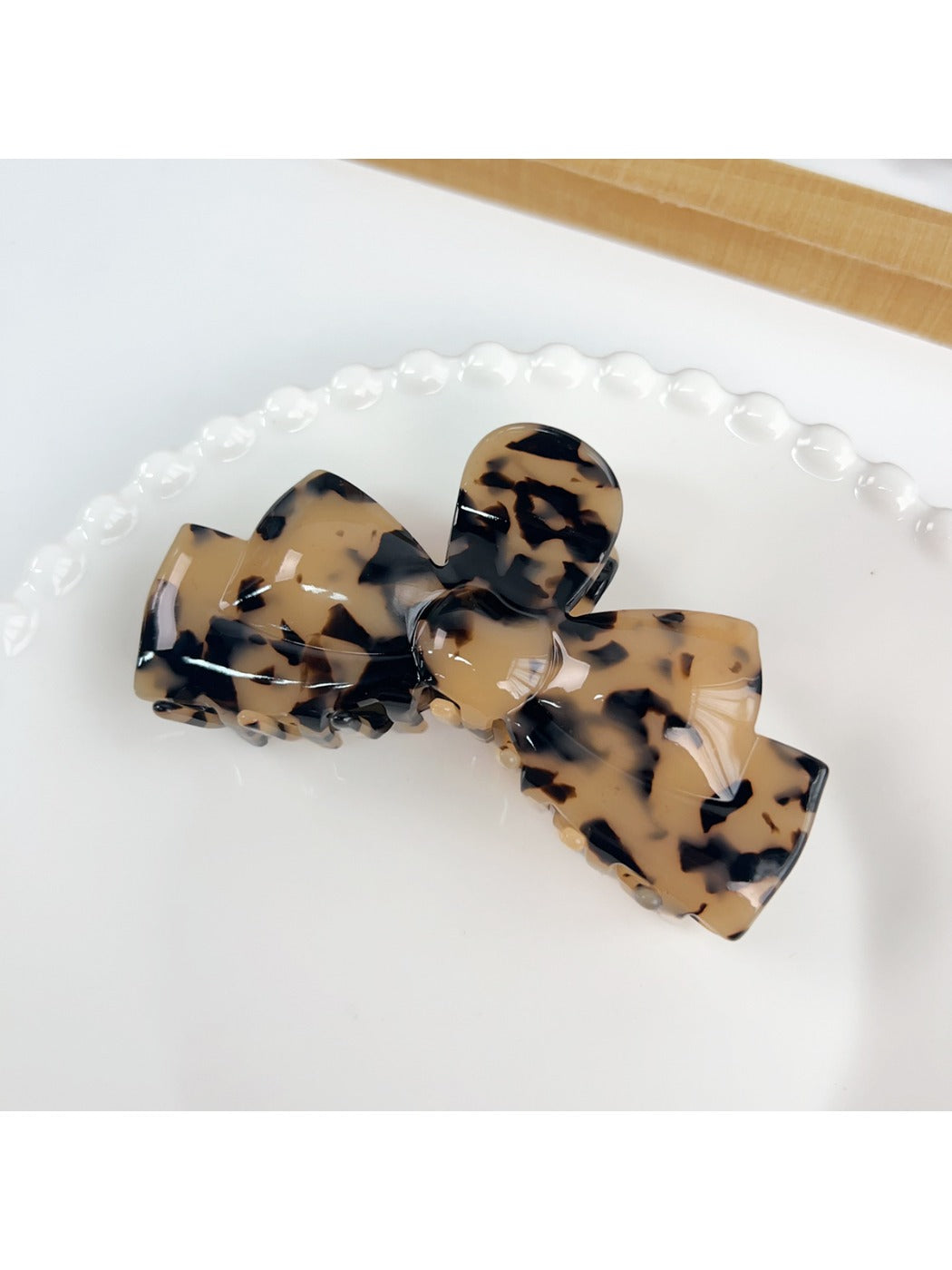 Beau hair claw clip shown with a soft shadow on white background