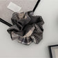 Gifty creative plaid patchwork scrunchie displayed on a white background