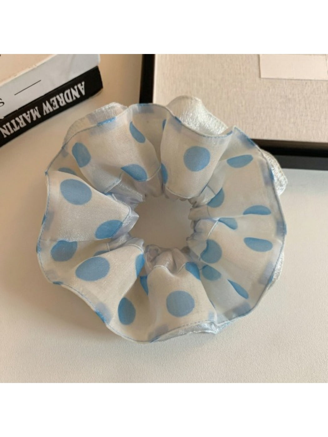 Gifty scrunchie styled on a wrist showing its elastic and fabric texture