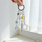 Star-shaped charm keychain displayed on a white background showing its shine