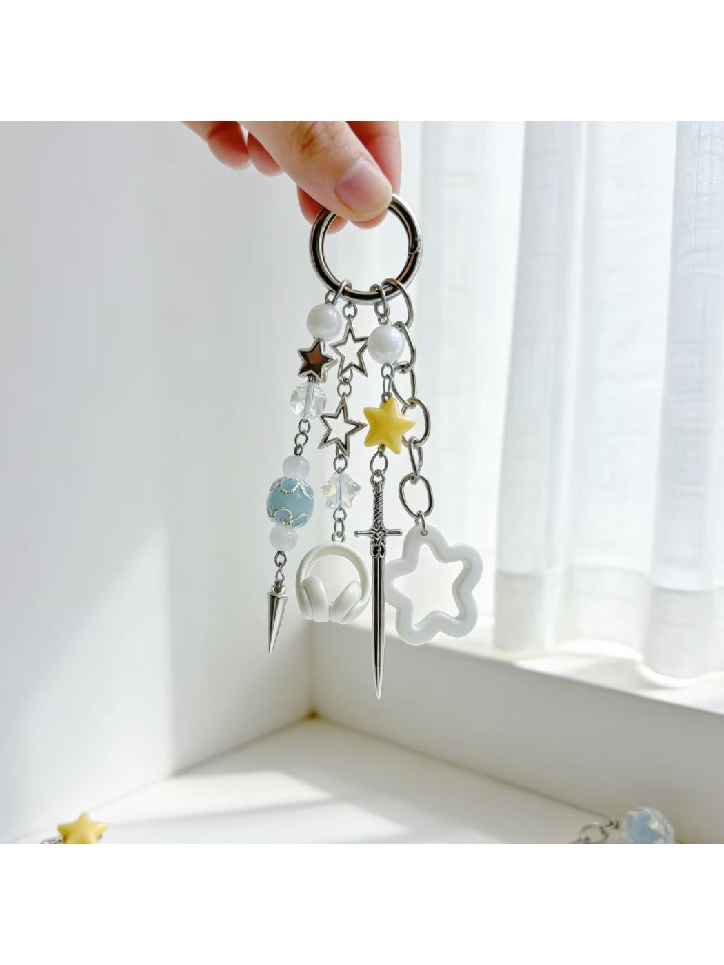 Star-shaped charm keychain displayed on a white background showing its shine