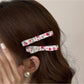 Side view of Beau floral print hair clip highlighting its smooth finish