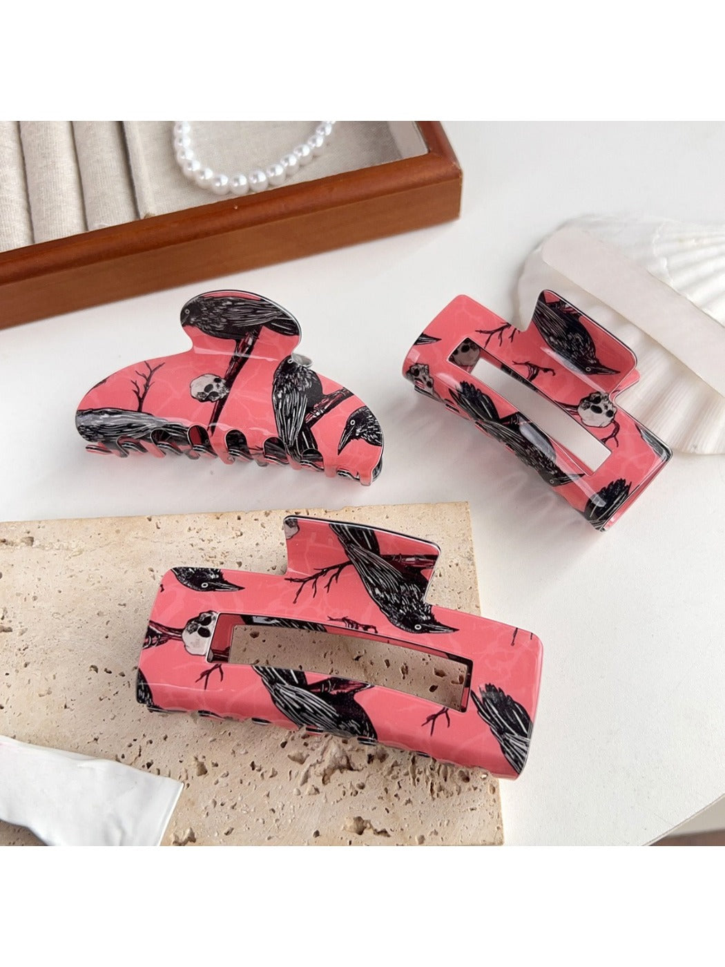Beau hair claw clip with black crow pattern on translucent material