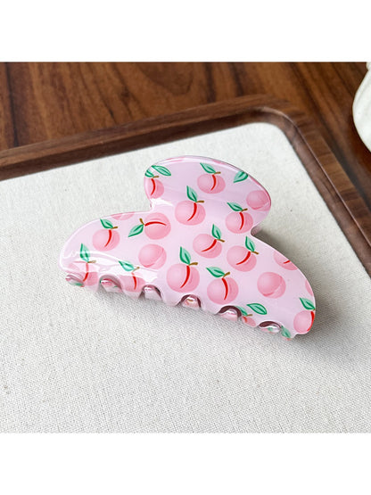 Top view of Beau fruit print acrylic claw clip showing curved shape