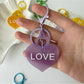 Blue heart-shaped pendant keychain shown hanging from a keyring