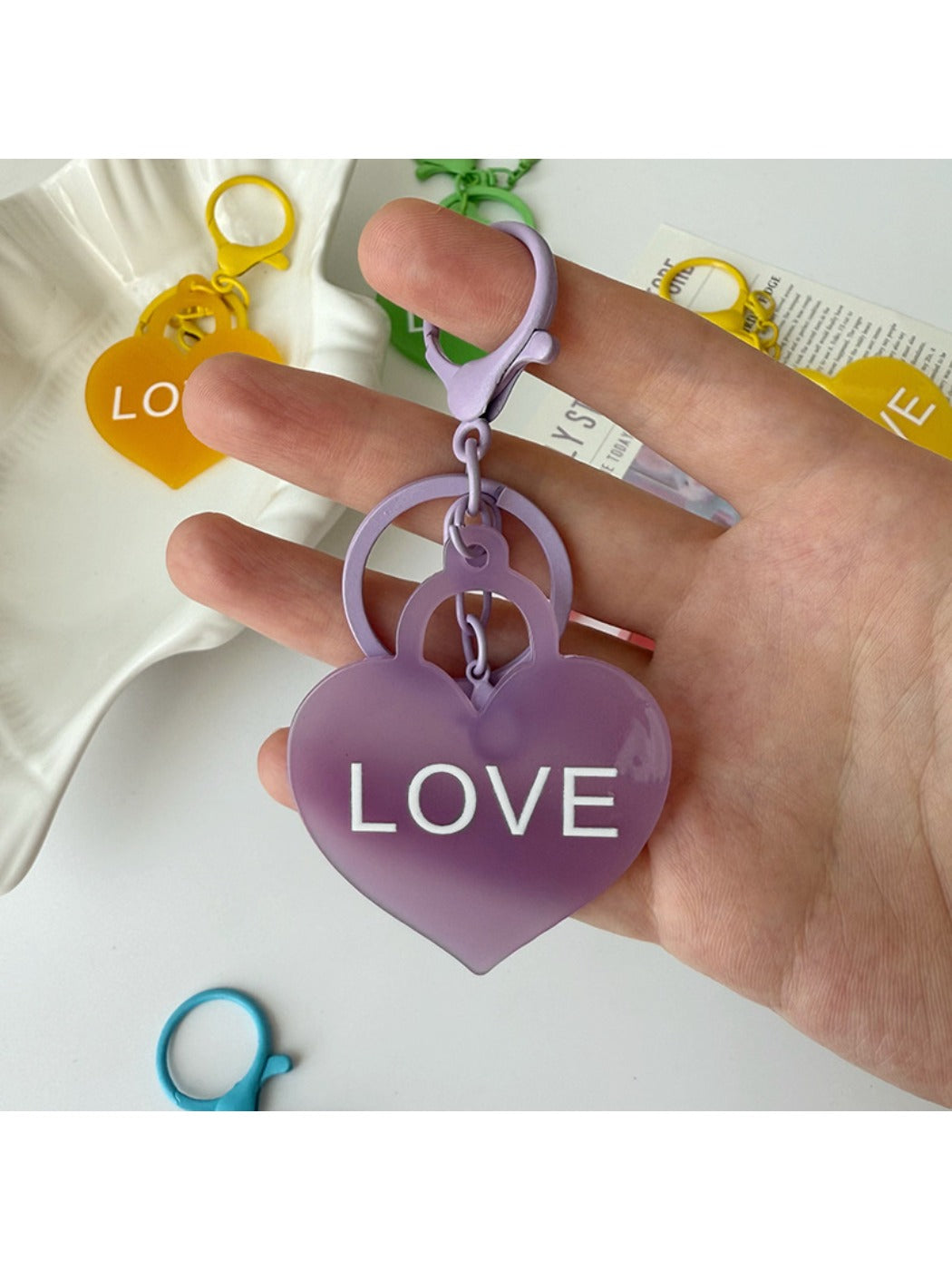 Blue heart-shaped pendant keychain shown hanging from a keyring