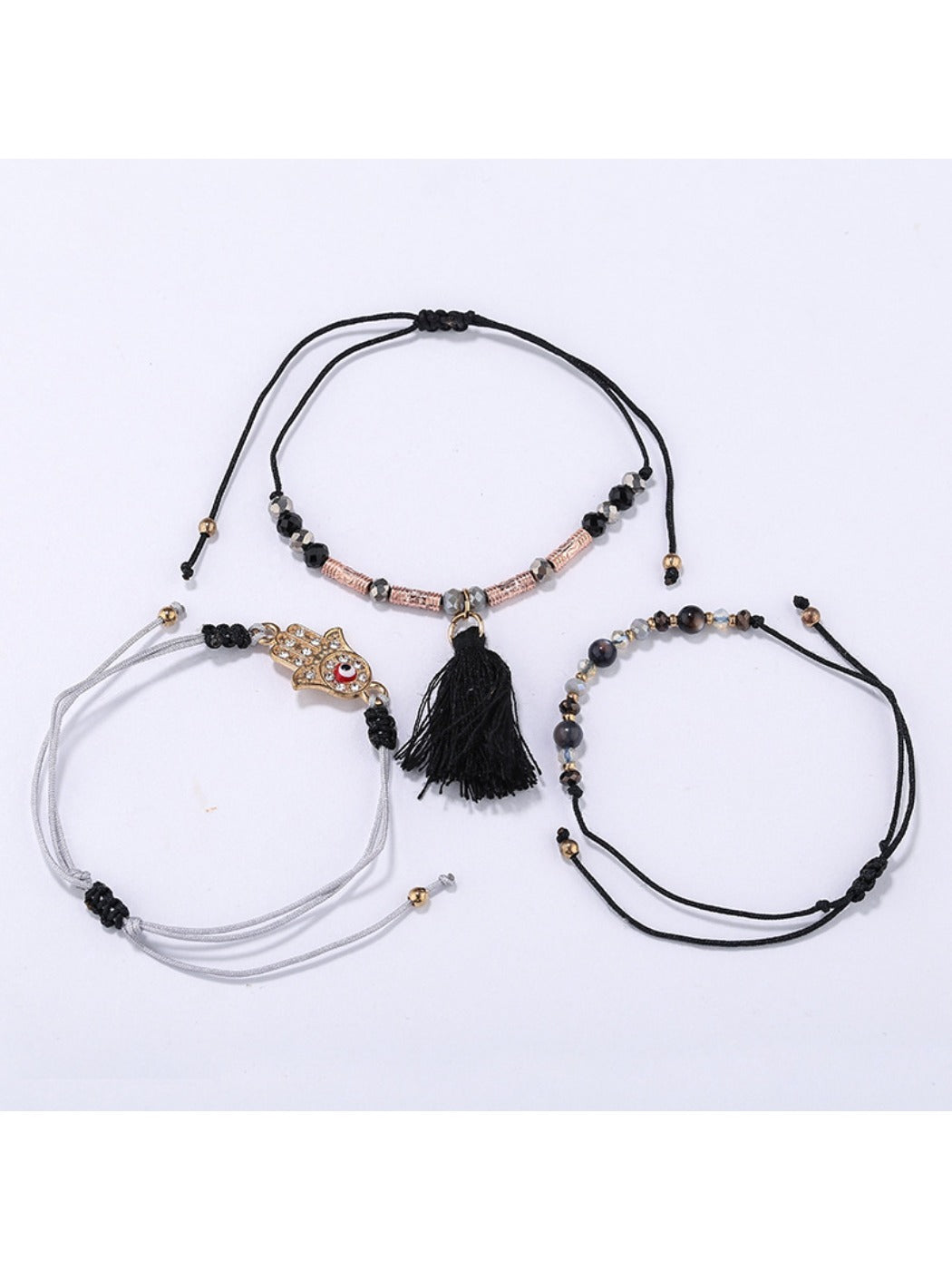 Close-up of Lovra alloy charm with tassel pendant on bracelet