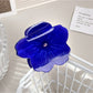 Beau hair claw clip in light pink, close-up showing petal texture and clasp
