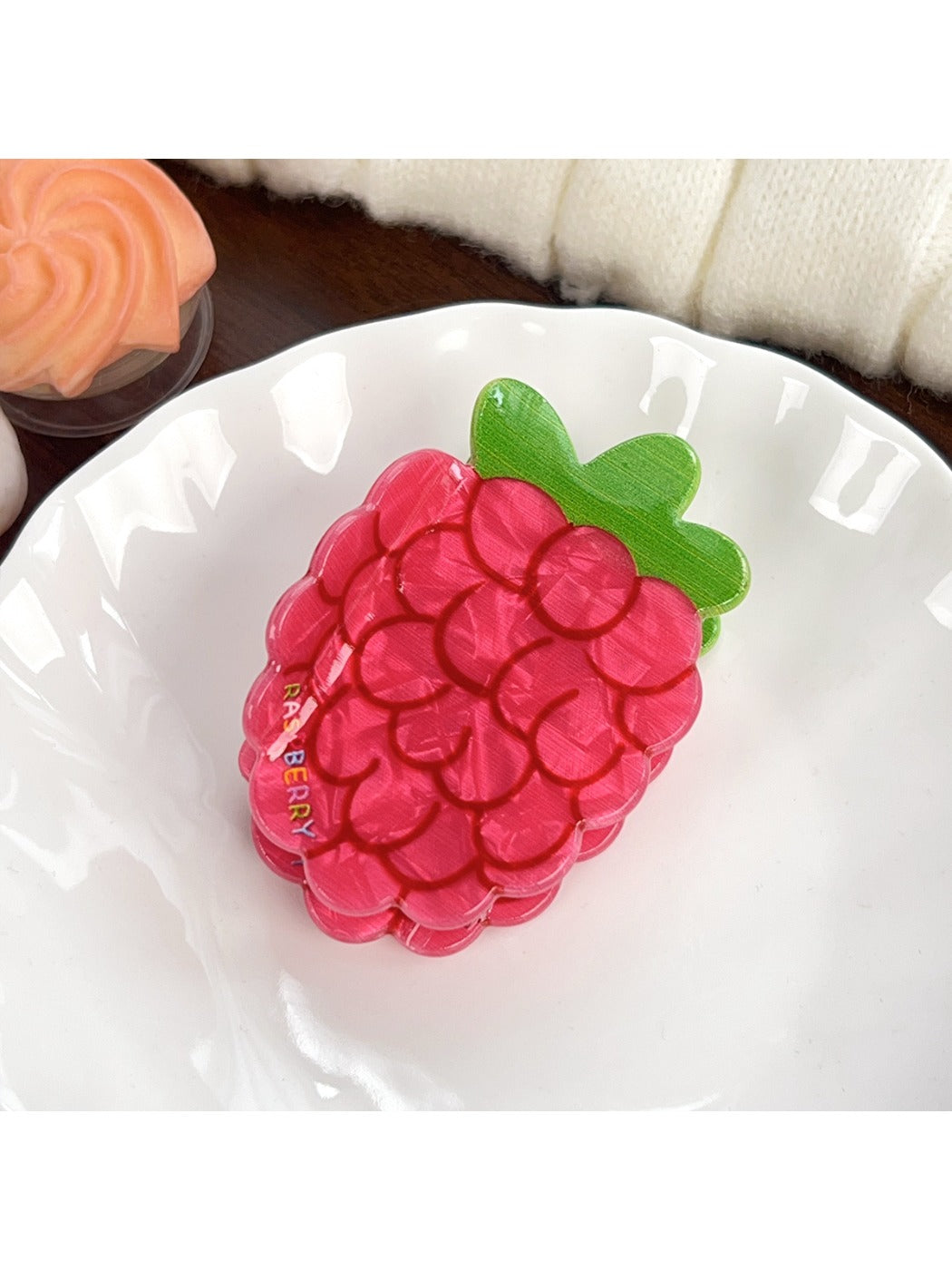 Set of colorful fruit shaped hair claw clips displayed on a flat surface