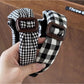 Black plaid clean headband displayed on a white background
