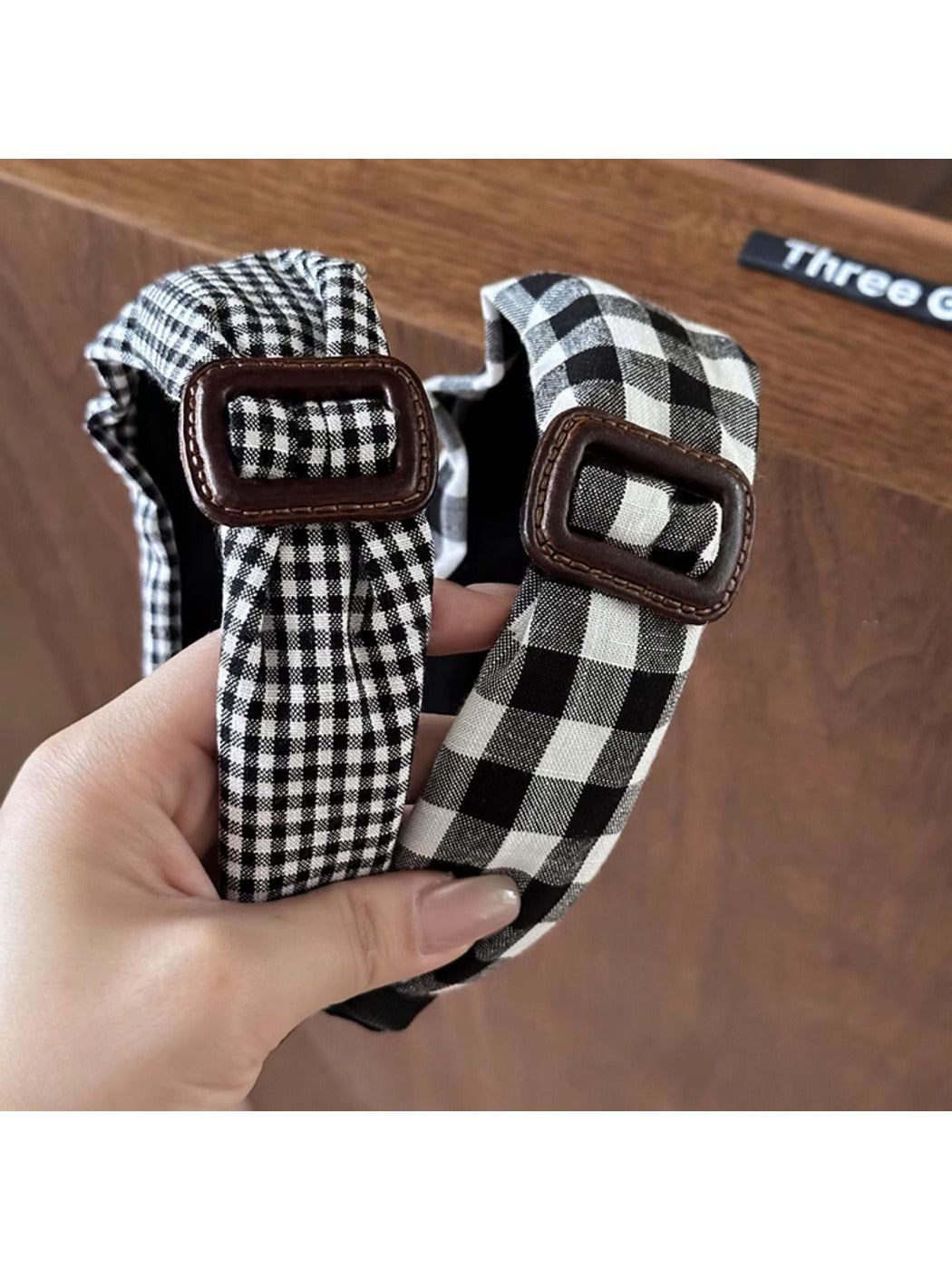 Black plaid clean headband displayed on a white background