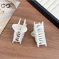 Close-up of Beau shark claw clip showing geometric design and matte finish
