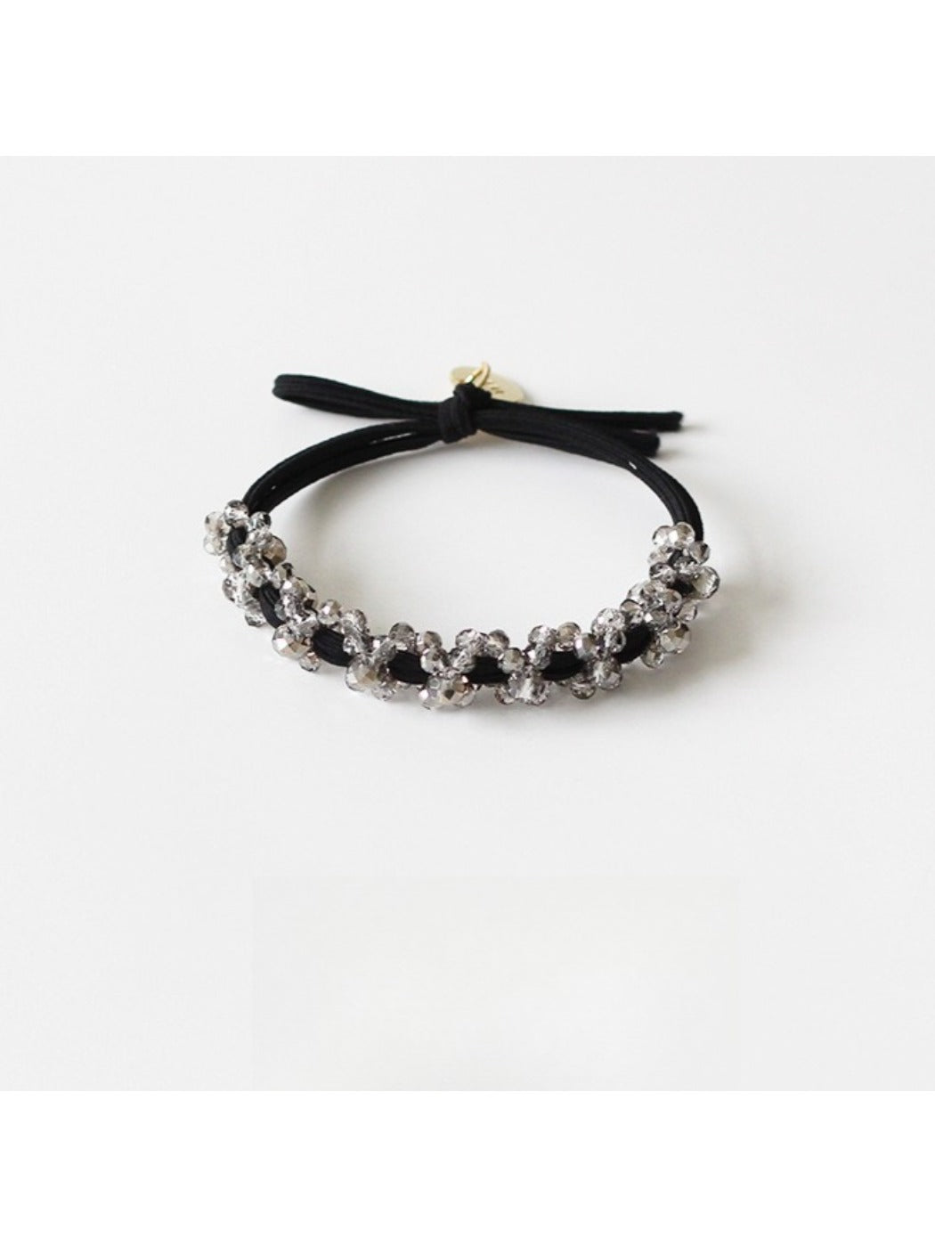 Gifty modern beaded hair tie securing a ponytail on dark hair