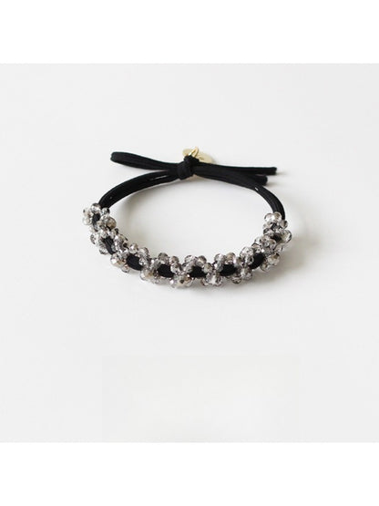 Gifty modern beaded hair tie securing a ponytail on dark hair