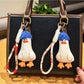 Close-up of blue duck keychain showing detailed hair texture and facial features