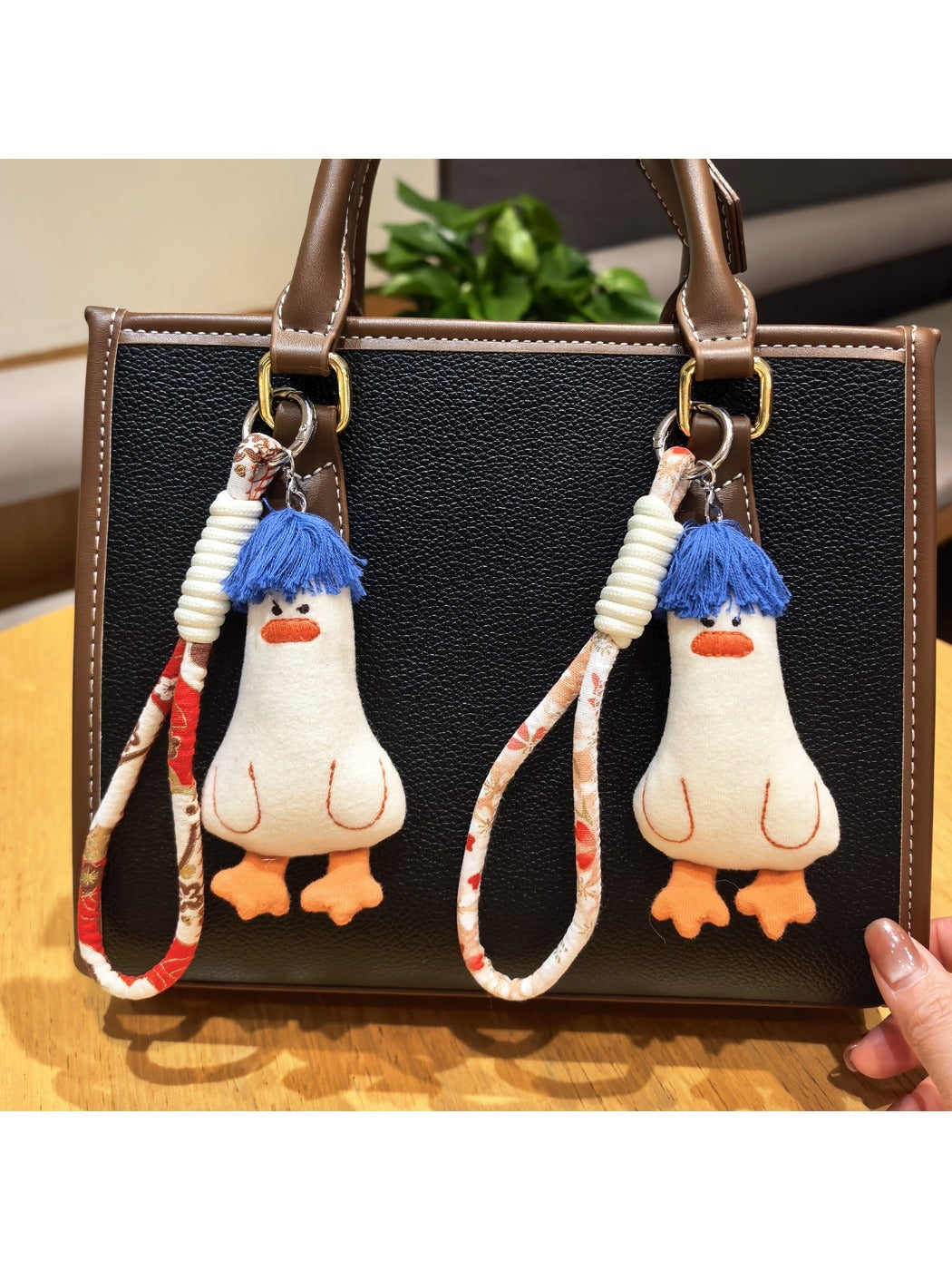 Close-up of blue duck keychain showing detailed hair texture and facial features