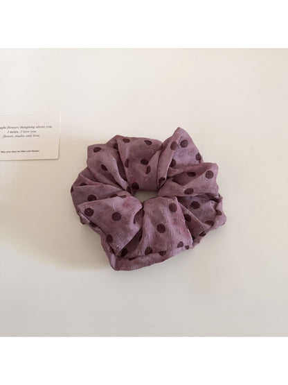 Gifty scrunchie styled in hair with visible floral and polka dot print