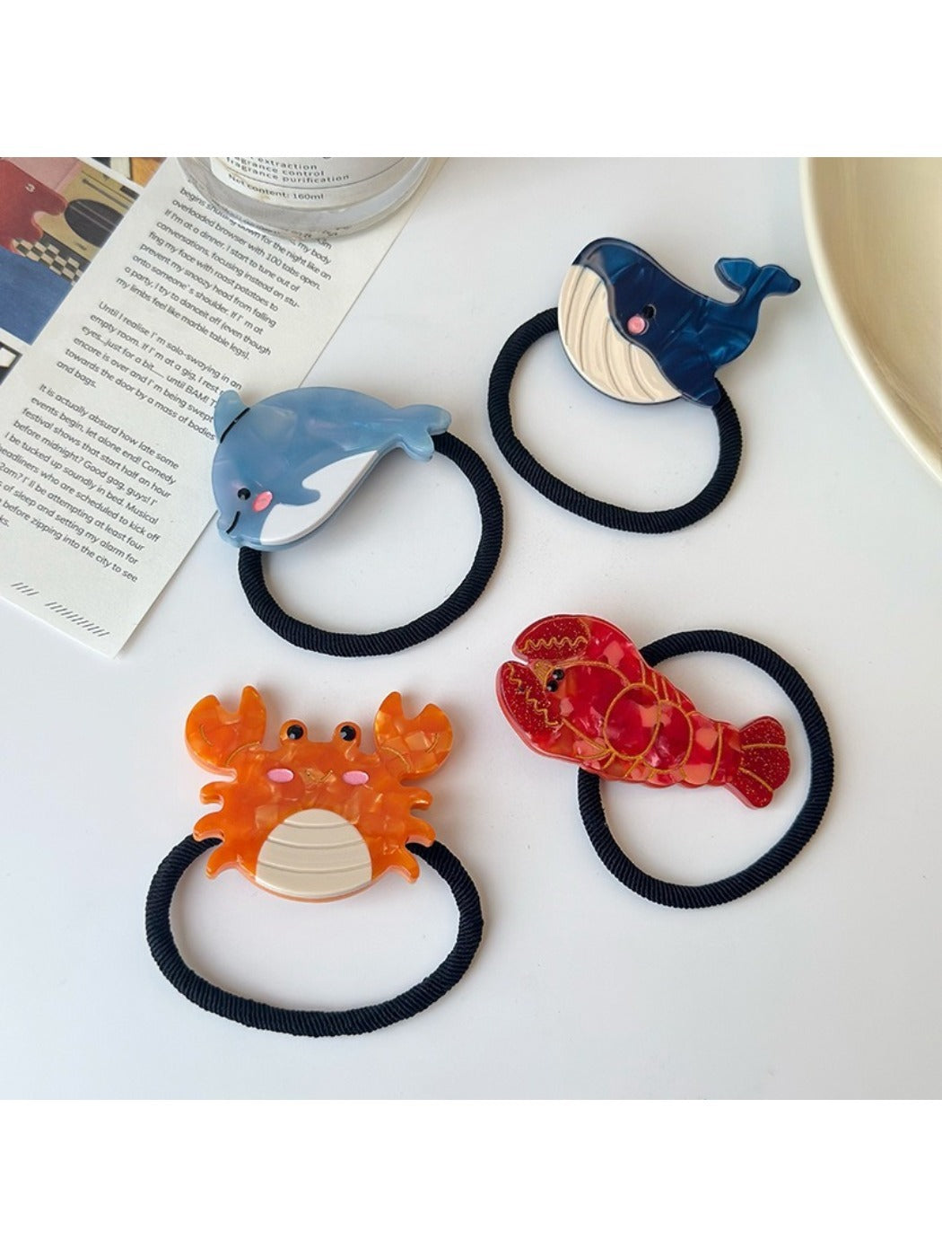 Close-up of Gifty hair tie showing detailed ocean animal illustrations on fabric
