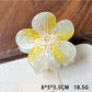 Beau acetate floral claw clip angled to show thickness and translucent quality