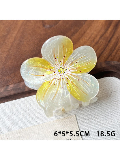 Beau acetate floral claw clip angled to show thickness and translucent quality