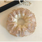 Side view of Gifty satin hair scrunchie showing gathered fabric and lace detail