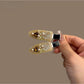 Beau hair clip placed on a wooden surface showcasing its elegant heart embellishment