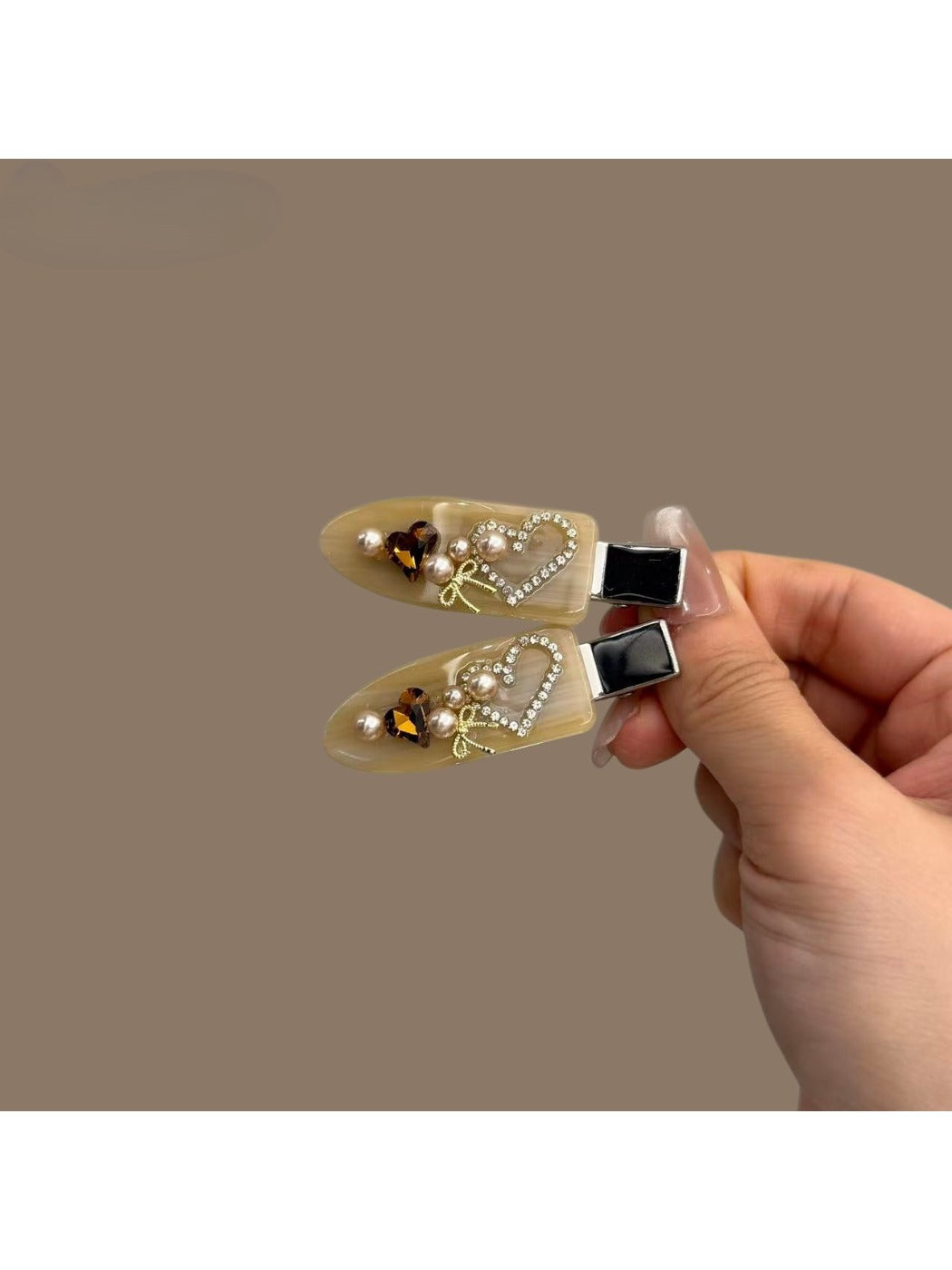 Beau hair clip placed on a wooden surface showcasing its elegant heart embellishment