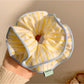 Side view of yellow striped hair scrunchie showing elastic band