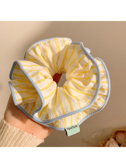 Side view of yellow striped hair scrunchie showing elastic band