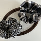 Close-up of black and white checkered fabric scrunchie showing texture