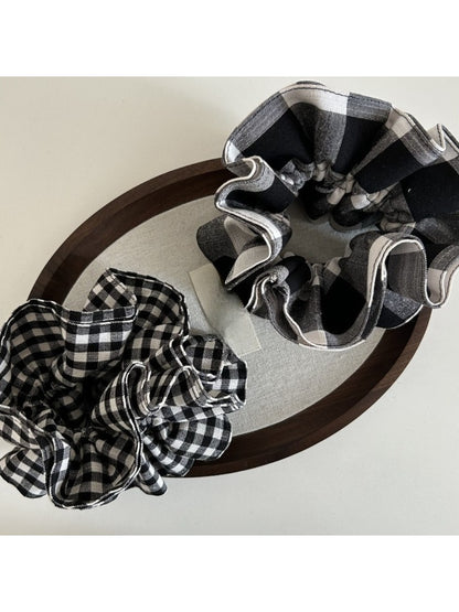 Close-up of black and white checkered fabric scrunchie showing texture