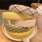 Close-up of yellow fabric headband showing texture and bow design