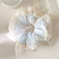 Gifty scrunchie styled in hair, emphasizing the bow and soft fabric appearance