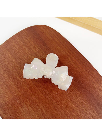 Beau hair claw clip placed next to matching hair accessories