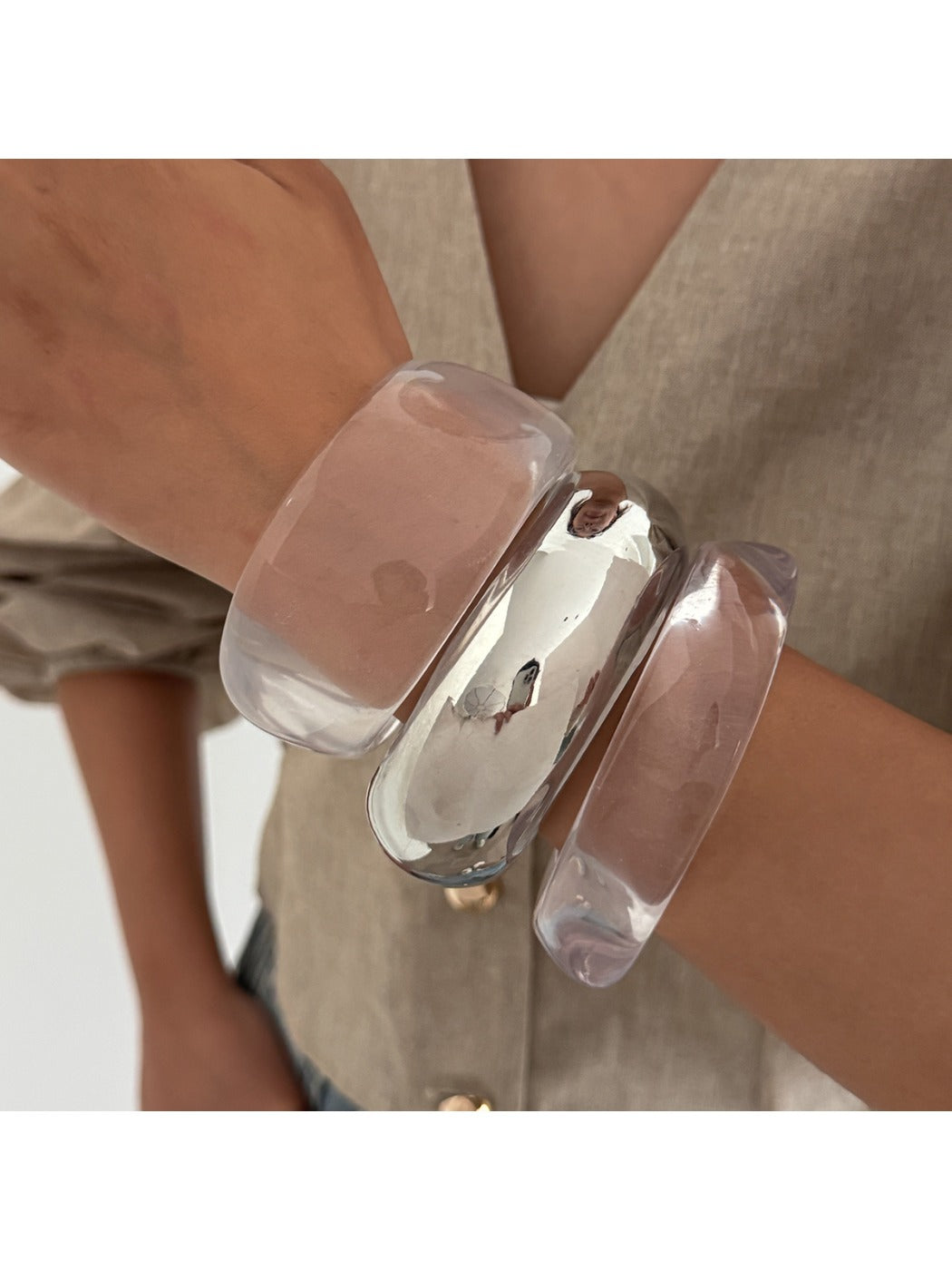 Lovra wide band bangle bracelet worn on wrist with casual outfit