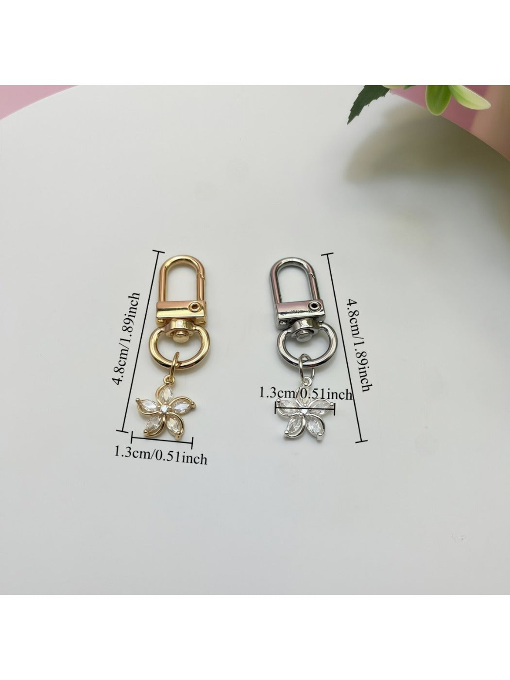 Keypus flower charm keychain displayed on a fabric pouch with soft lighting