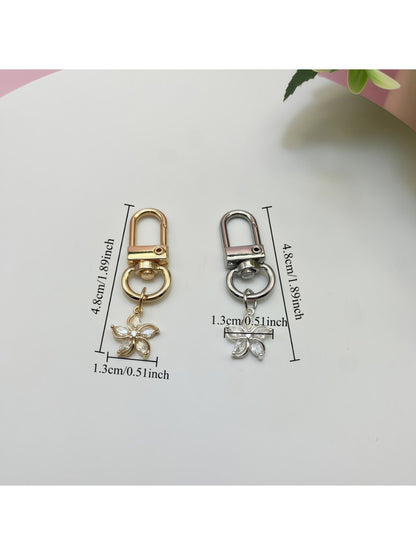 Keypus flower charm keychain displayed on a fabric pouch with soft lighting