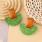 Earedge raffia mushroom shaped stud earrings in natural light with shadows