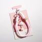 Hand holding the cloud and star shaped keychain with soft lighting