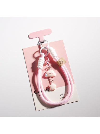 Hand holding the cloud and star shaped keychain with soft lighting