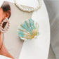 Beau shell shaped hair claw clip in natural light emphasizing texture
