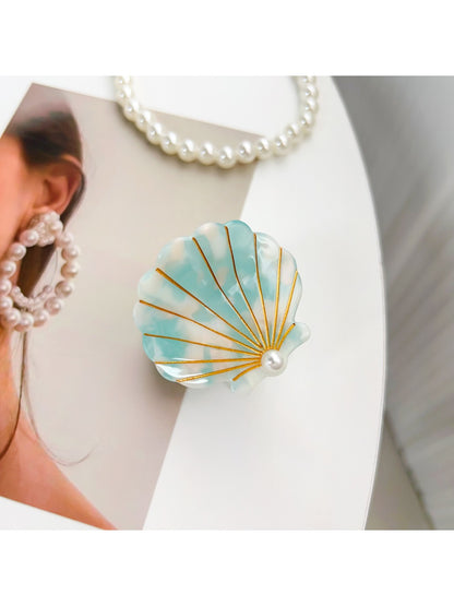 Beau shell shaped hair claw clip in natural light emphasizing texture