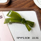 Beau acetate hair clip displayed with other hair accessories on table