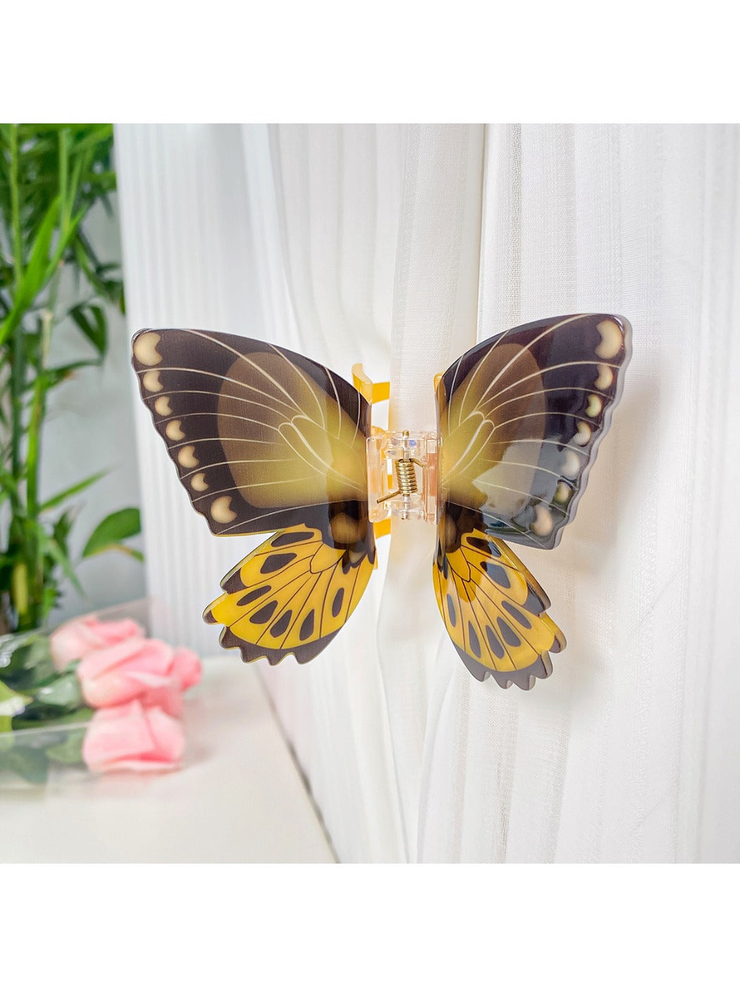 Beau butterfly hair claw clip resting on wooden surface