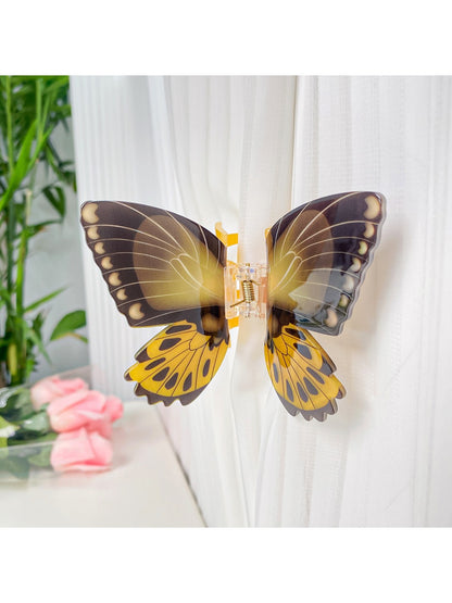 Beau butterfly hair claw clip resting on wooden surface
