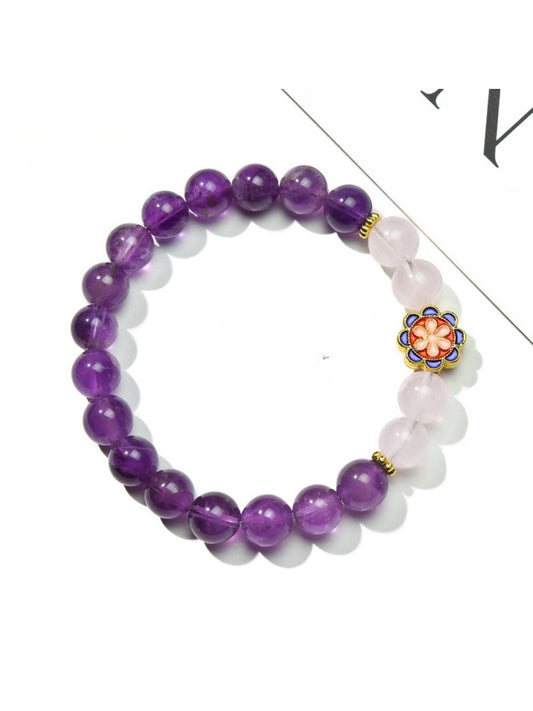 Lovra vintage floral accented beaded bracelet with pink and gold beads on white background