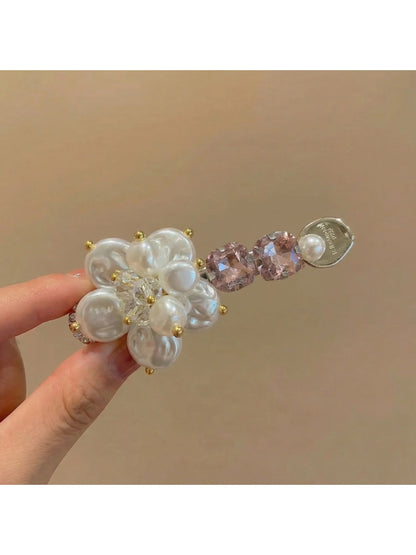 Beau Sweet Style flower hair clip held in hand showing size and design