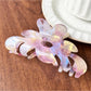 Beau flower shaped claw clip photographed with natural lighting on white