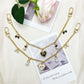 Heart bow pendant bag charm attached to a beige handbag strap