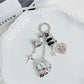 Minimalist heart shaped charm keychain in silver on a white background